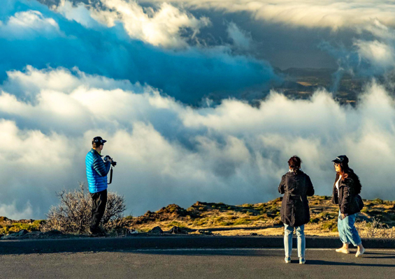 haleakala sunset clouds and visitors at overlook maui slider