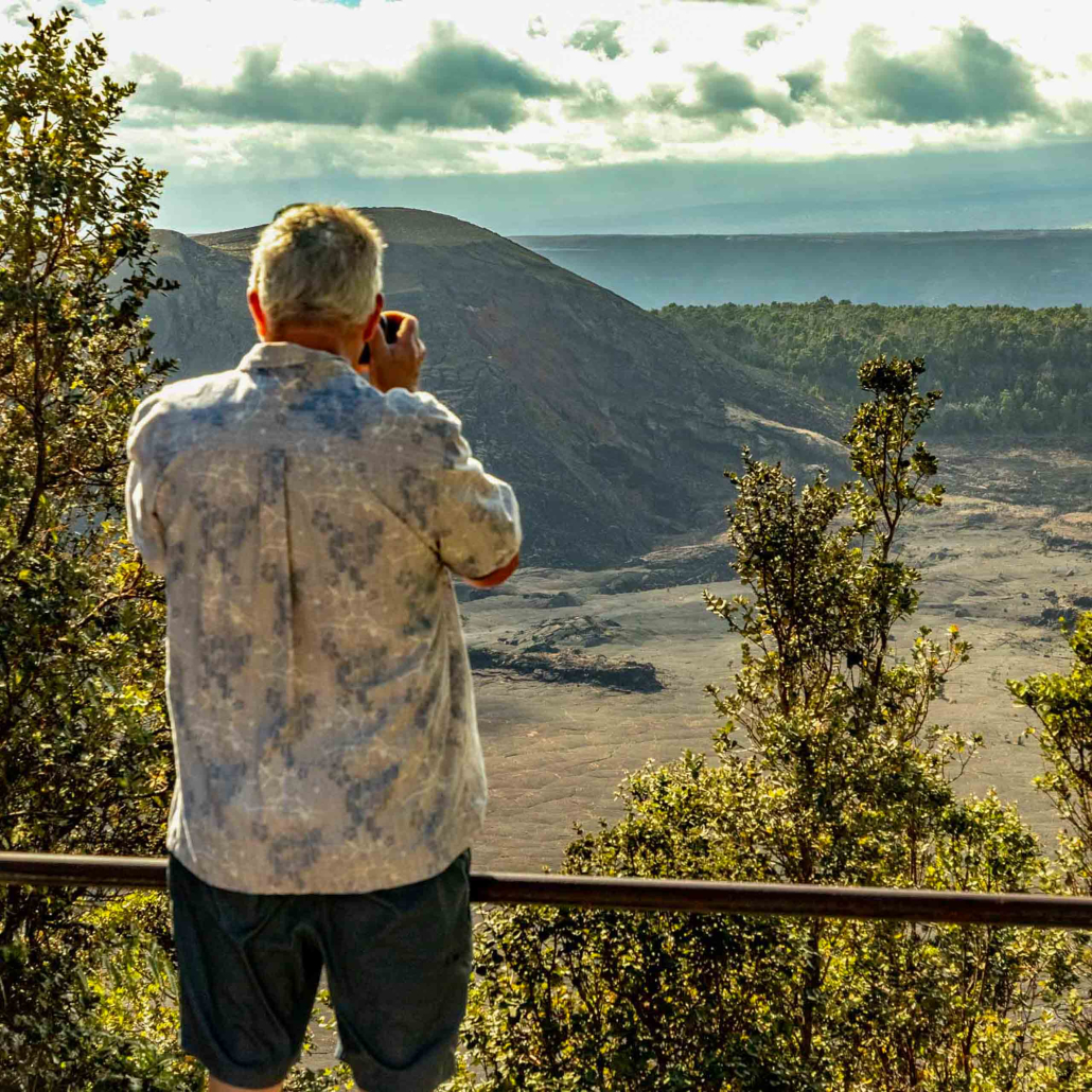 visitor photographs kilauea Iki in volcanoes national park big island hawaii