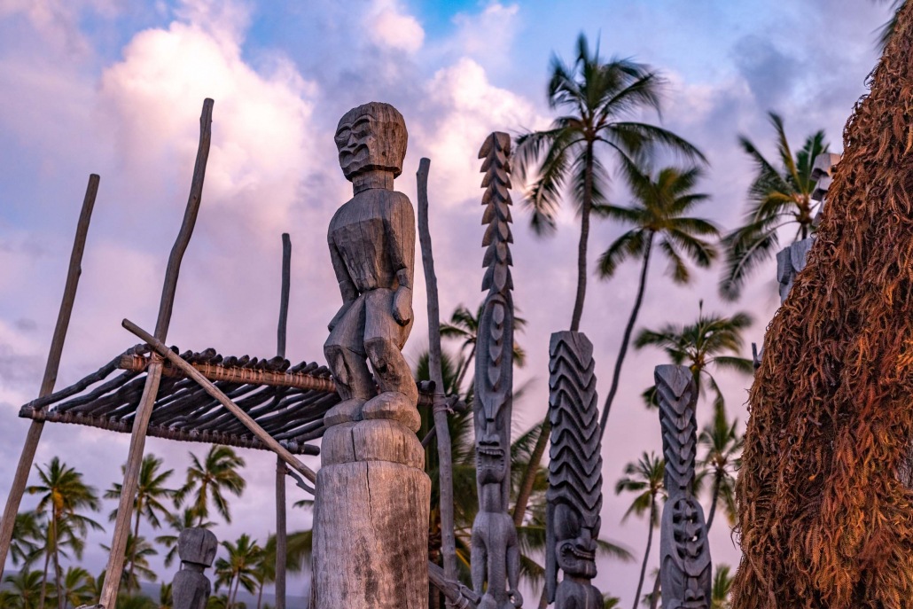 Wood carving at a Hawaiian temple glow in the setting sun