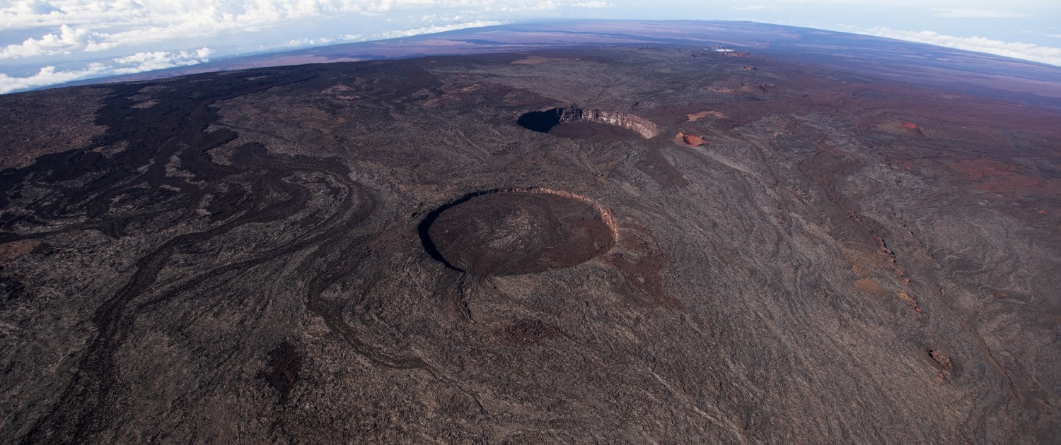 a view looking down mauna loas southwest rift with pit craters lua hohonu and lua hou mauna loa overflight paradise helicopters big island wednesday july